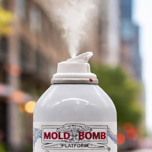 Close-up of MOLD BOMB fogger can actively spraying mist from nozzle with blurred urban background sixpack